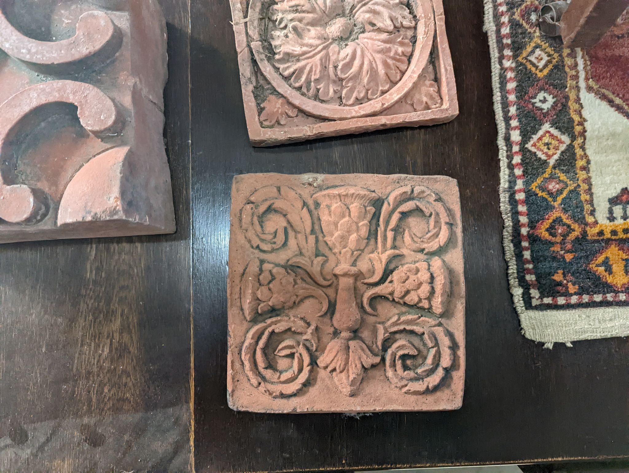 Five square terracotta garden tiles, largest width 22cm, depth 14cm